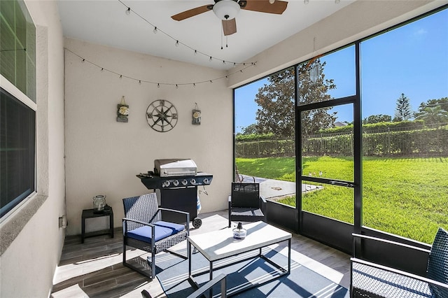 sunroom / solarium featuring ceiling fan