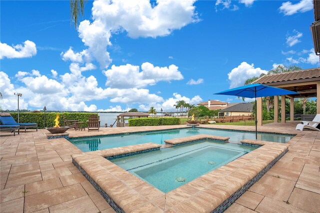 view of pool featuring an in ground hot tub and a patio