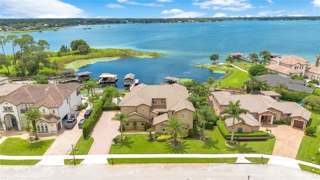 drone / aerial view with a water view and a residential view