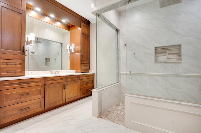 full bathroom featuring marble finish floor, a marble finish shower, and vanity