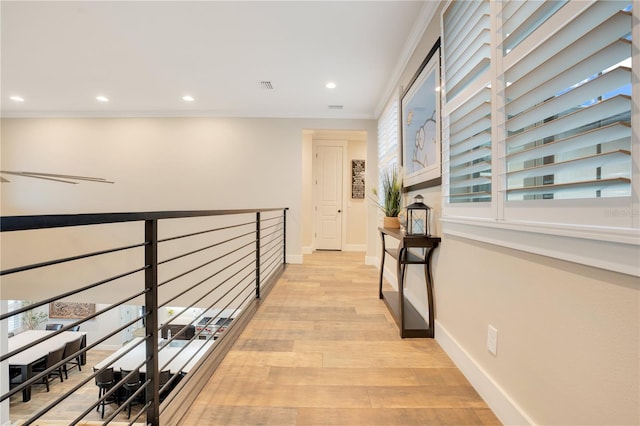 hall featuring light wood-type flooring, visible vents, baseboards, and recessed lighting