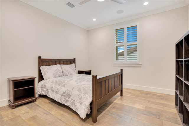 bedroom featuring light wood-style floors, baseboards, visible vents, and crown molding