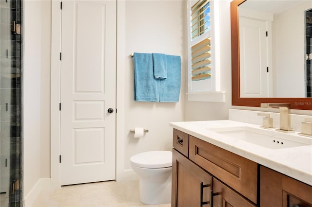 full bathroom with toilet, a stall shower, vanity, and baseboards