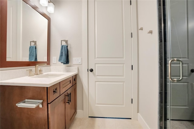 bathroom featuring baseboards, a shower stall, vanity, and tile patterned floors