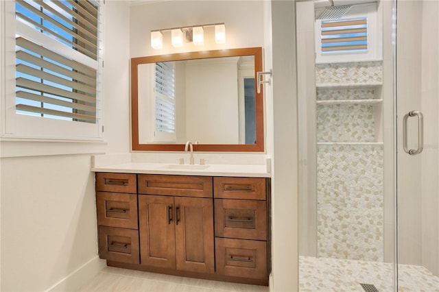 full bathroom featuring a shower stall, baseboards, and vanity