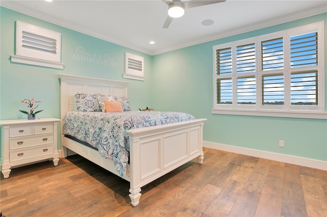 bedroom featuring recessed lighting, wood finished floors, a ceiling fan, baseboards, and ornamental molding