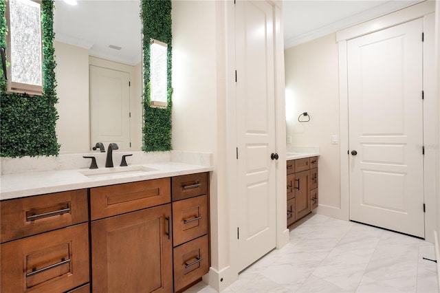 bathroom with marble finish floor, ornamental molding, and vanity