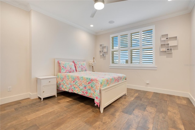 bedroom with baseboards, wood finished floors, a ceiling fan, and crown molding