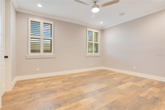 empty room featuring baseboards, ornamental molding, and light wood-style floors