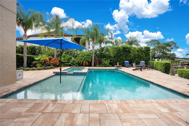 view of swimming pool with a patio area and a pool with connected hot tub