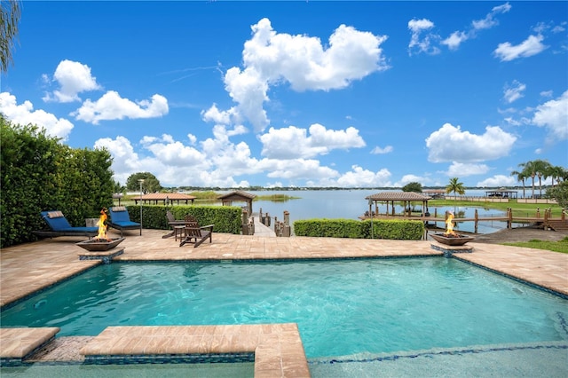 outdoor pool with a water view, a patio area, an outdoor fire pit, and a gazebo