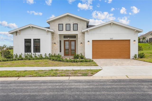 197 Valencia Ridge Dr, Auburndale, FL 33823 - contemporary home featuring french doors, a garage, driveway, and stucco siding