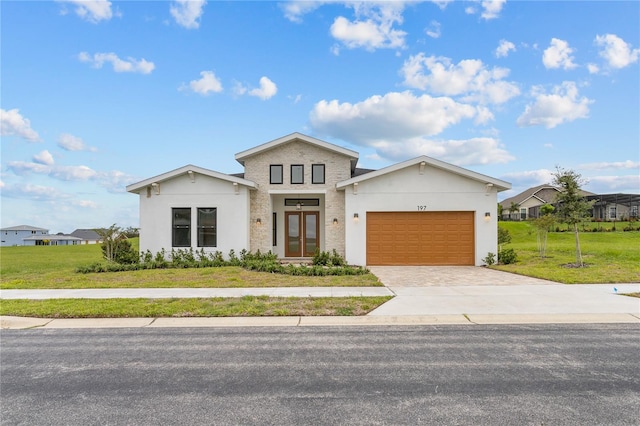 view of front of property featuring a front yard and a garage