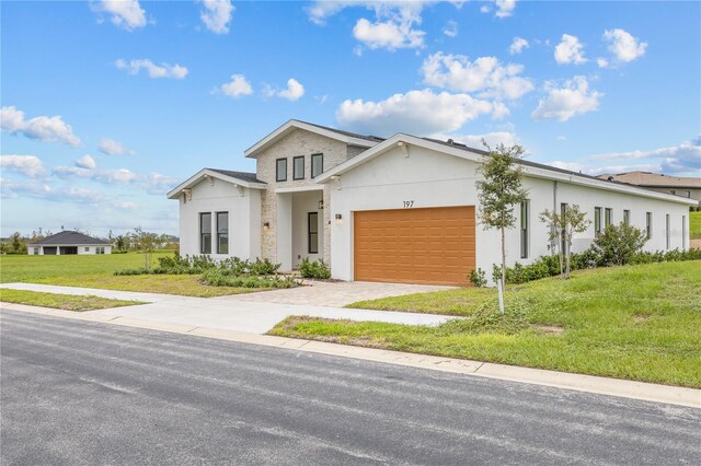 197 Valencia Ridge Dr, Auburndale, FL 33823 - view of front of home featuring a garage, a front yard, stucco siding, and driveway