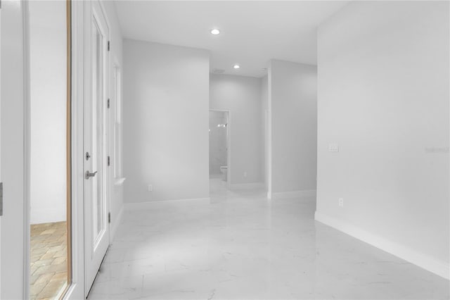 197 Valencia Ridge Dr, Auburndale, FL 33823 - hall featuring light marble finish floors, recessed lighting, and baseboards