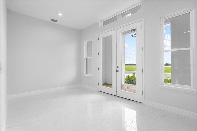 197 Valencia Ridge Dr, Auburndale, FL 33823 - unfurnished room with french doors, light marble finish flooring, baseboards, and recessed lighting