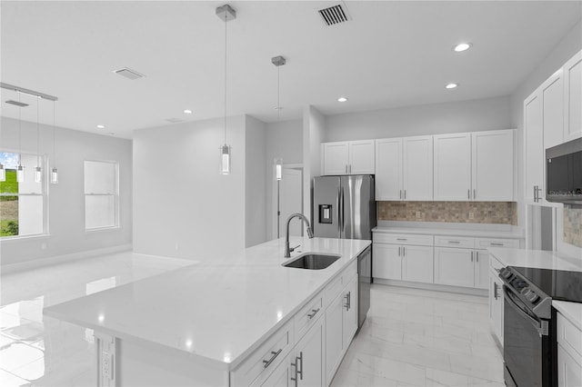 kitchen with white cabinetry, a large island with sink, decorative light fixtures, and stainless steel appliances