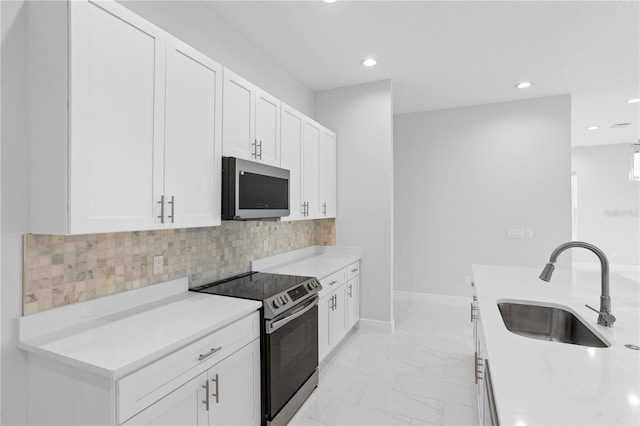 kitchen featuring sink, appliances with stainless steel finishes, and white cabinetry