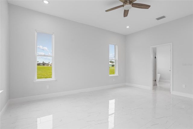 empty room with a healthy amount of sunlight and ceiling fan