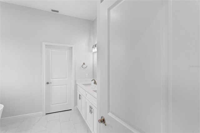 197 Valencia Ridge Dr, Auburndale, FL 33823 - bathroom with marble finish flooring, vanity, and baseboards