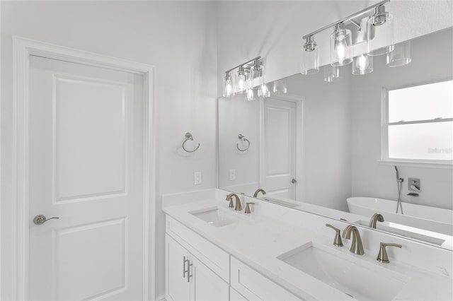 bathroom featuring vanity and a tub