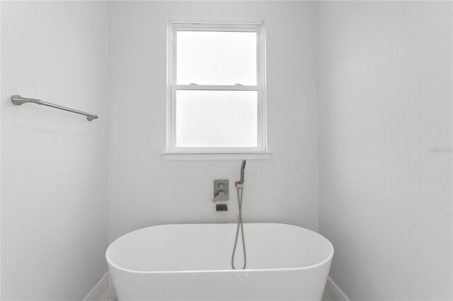 197 Valencia Ridge Dr, Auburndale, FL 33823 - bathroom featuring a freestanding bath and baseboards