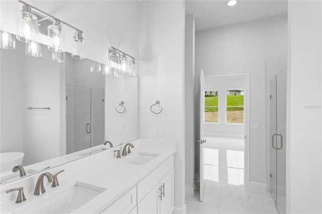 bathroom with a shower with door and vanity