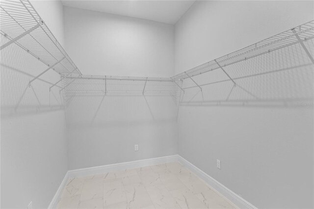 197 Valencia Ridge Dr, Auburndale, FL 33823 - walk in closet with light marble finish flooring