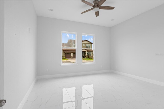 197 Valencia Ridge Dr, Auburndale, FL 33823 - spare room with light marble finish floors, a ceiling fan, and baseboards