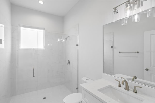 bathroom featuring vanity, toilet, and an enclosed shower