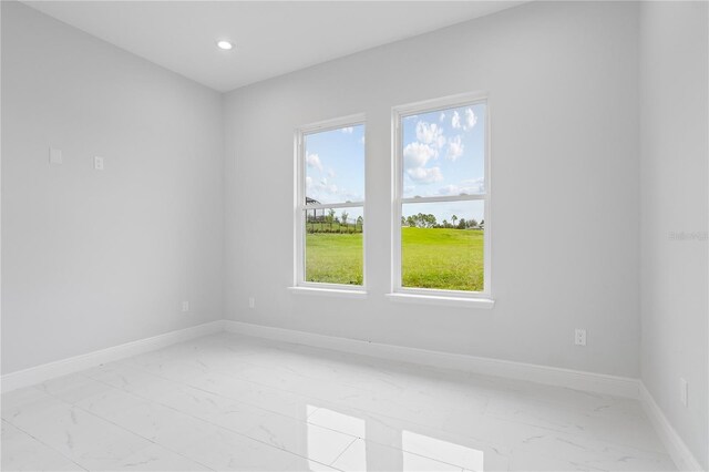 197 Valencia Ridge Dr, Auburndale, FL 33823 - unfurnished room with light marble finish flooring, baseboards, recessed lighting, and a water view