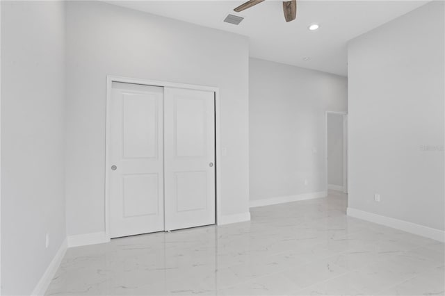 197 Valencia Ridge Dr, Auburndale, FL 33823 - unfurnished bedroom with light marble finish flooring, recessed lighting, a closet, baseboards, and a ceiling fan