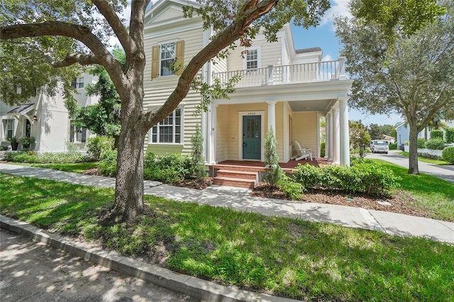 view of front of house with a balcony and covered porch