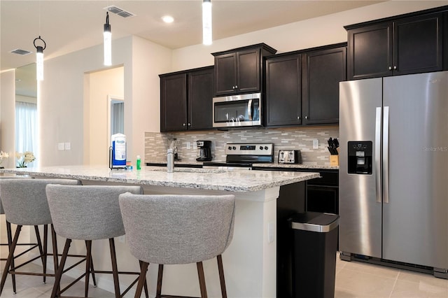 kitchen with tasteful backsplash, visible vents, and appliances with stainless steel finishes