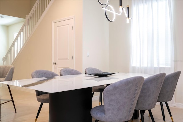 dining space with a notable chandelier, stairway, and baseboards