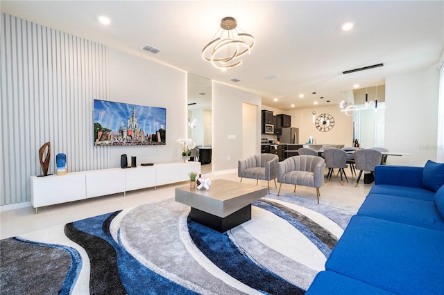 living room featuring light tile patterned floors and a notable chandelier