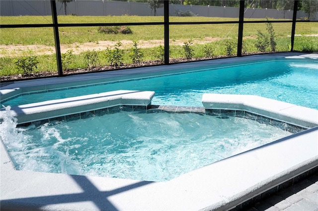 view of swimming pool with a lanai and a pool with connected hot tub