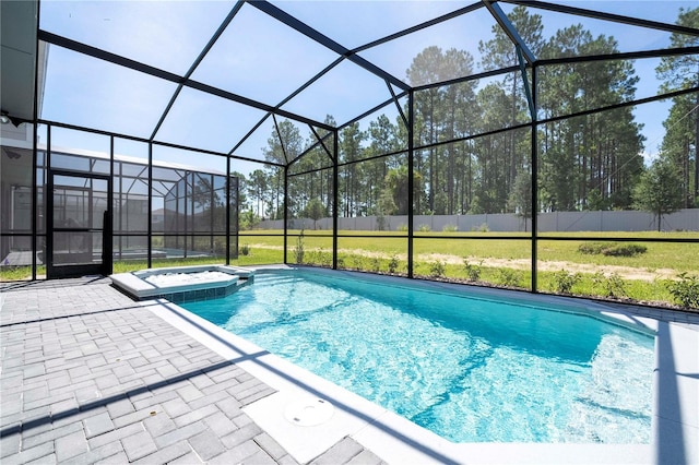 view of pool featuring glass enclosure, a pool with connected hot tub, a patio, and fence