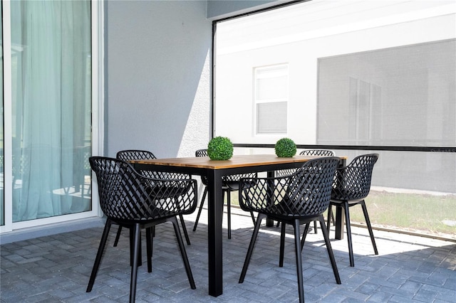 dining room featuring brick floor