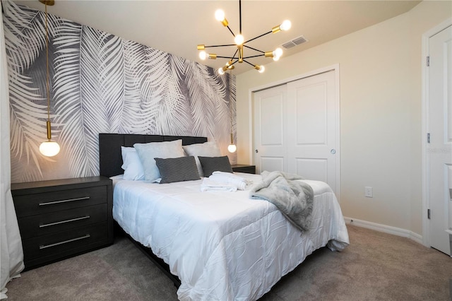 carpeted bedroom featuring visible vents, a closet, wallpapered walls, baseboards, and an accent wall