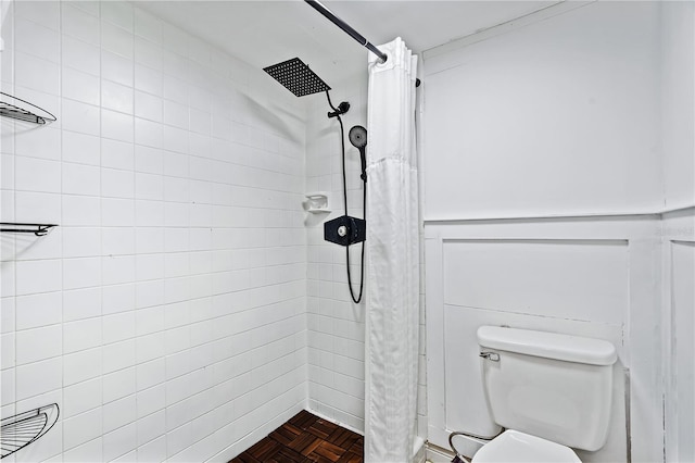 bathroom with a shower with curtain, toilet, and parquet flooring