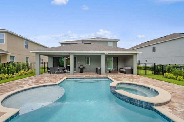 view of swimming pool with a patio and an in ground hot tub