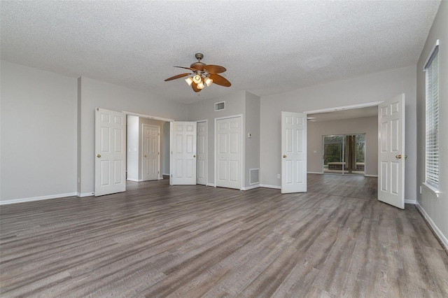 unfurnished bedroom featuring ceiling fan, light hardwood / wood-style floors, and a textured ceiling