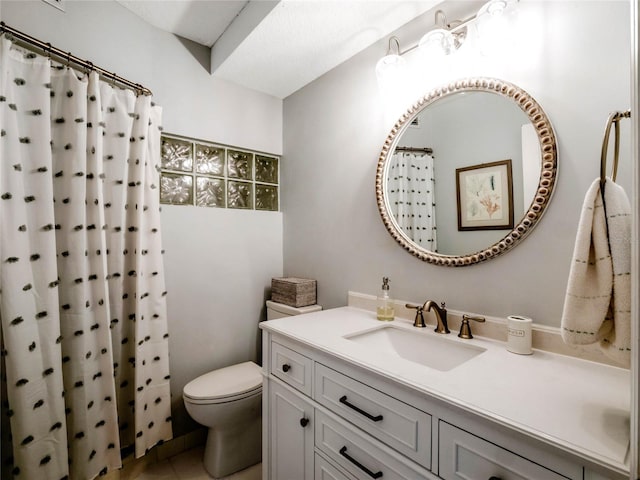 bathroom with vanity, a shower with shower curtain, and toilet