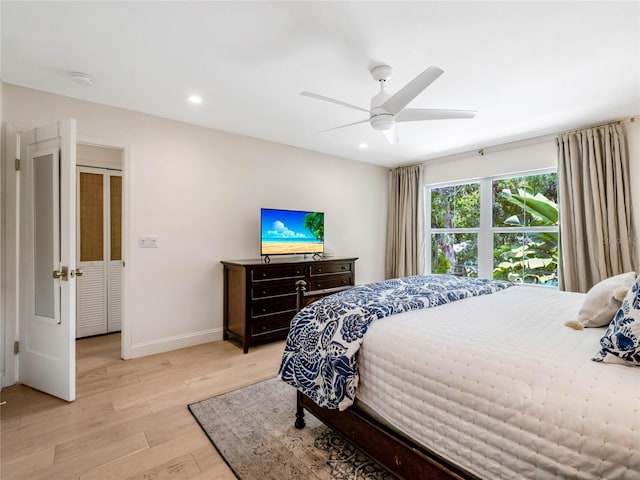 bedroom with ceiling fan and light wood-type flooring