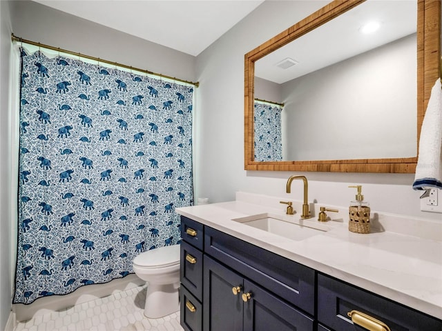 bathroom featuring vanity, tile patterned floors, and toilet