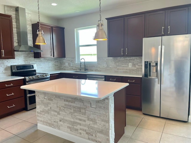 kitchen with wall chimney exhaust hood, appliances with stainless steel finishes, a sink, and light tile patterned flooring