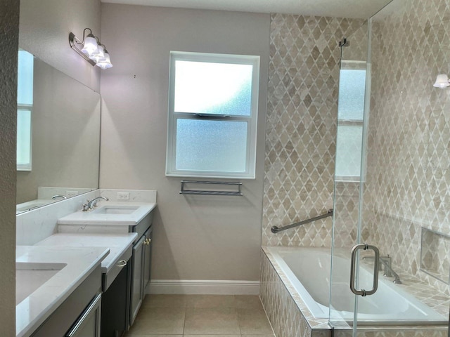 bathroom featuring double vanity, tiled bath, tiled shower, tile patterned floors, and a sink