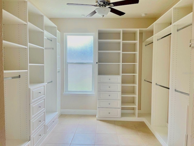 spacious closet with light tile patterned floors and ceiling fan