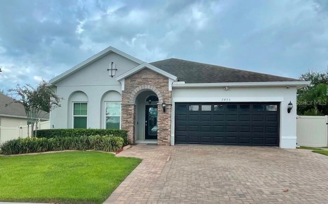 view of front facade featuring a front lawn and a garage